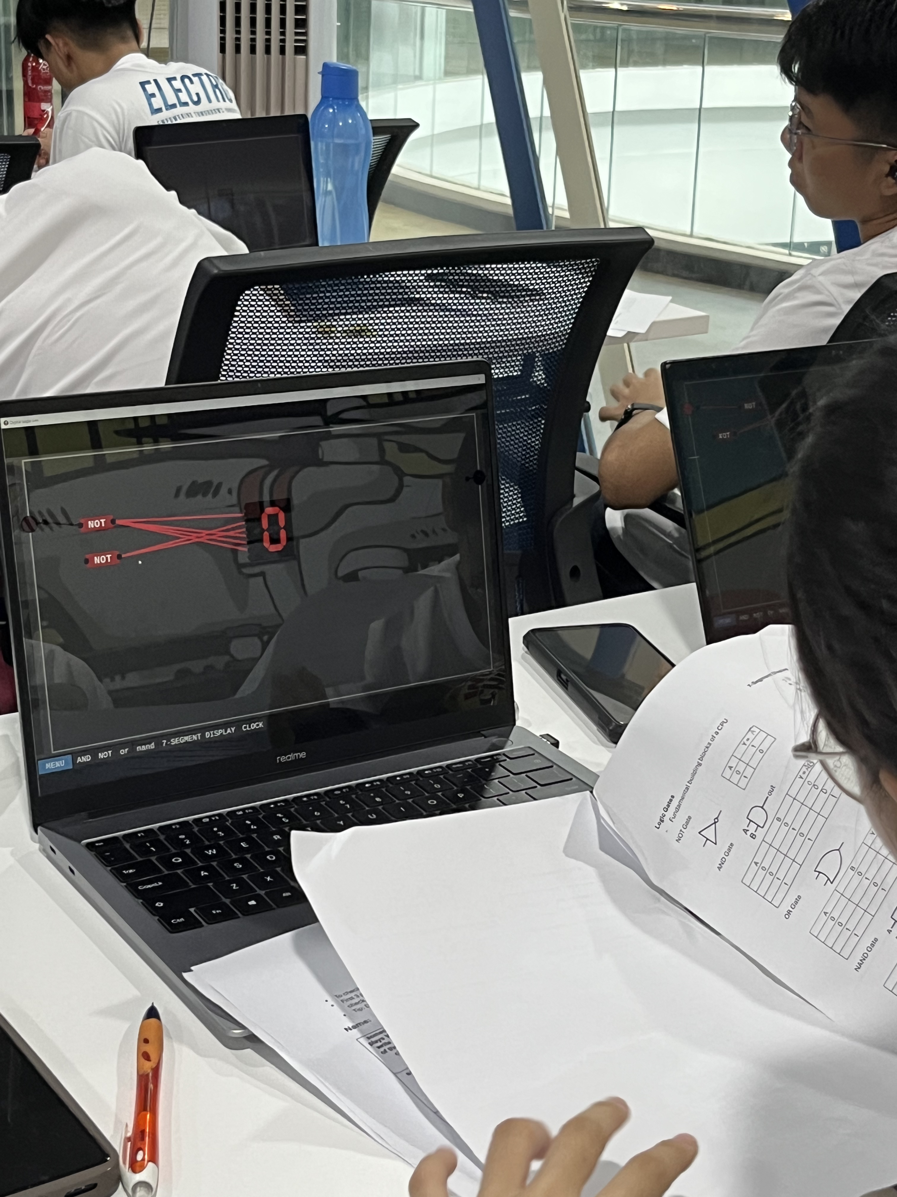 Students working with logic gate simulation tools
